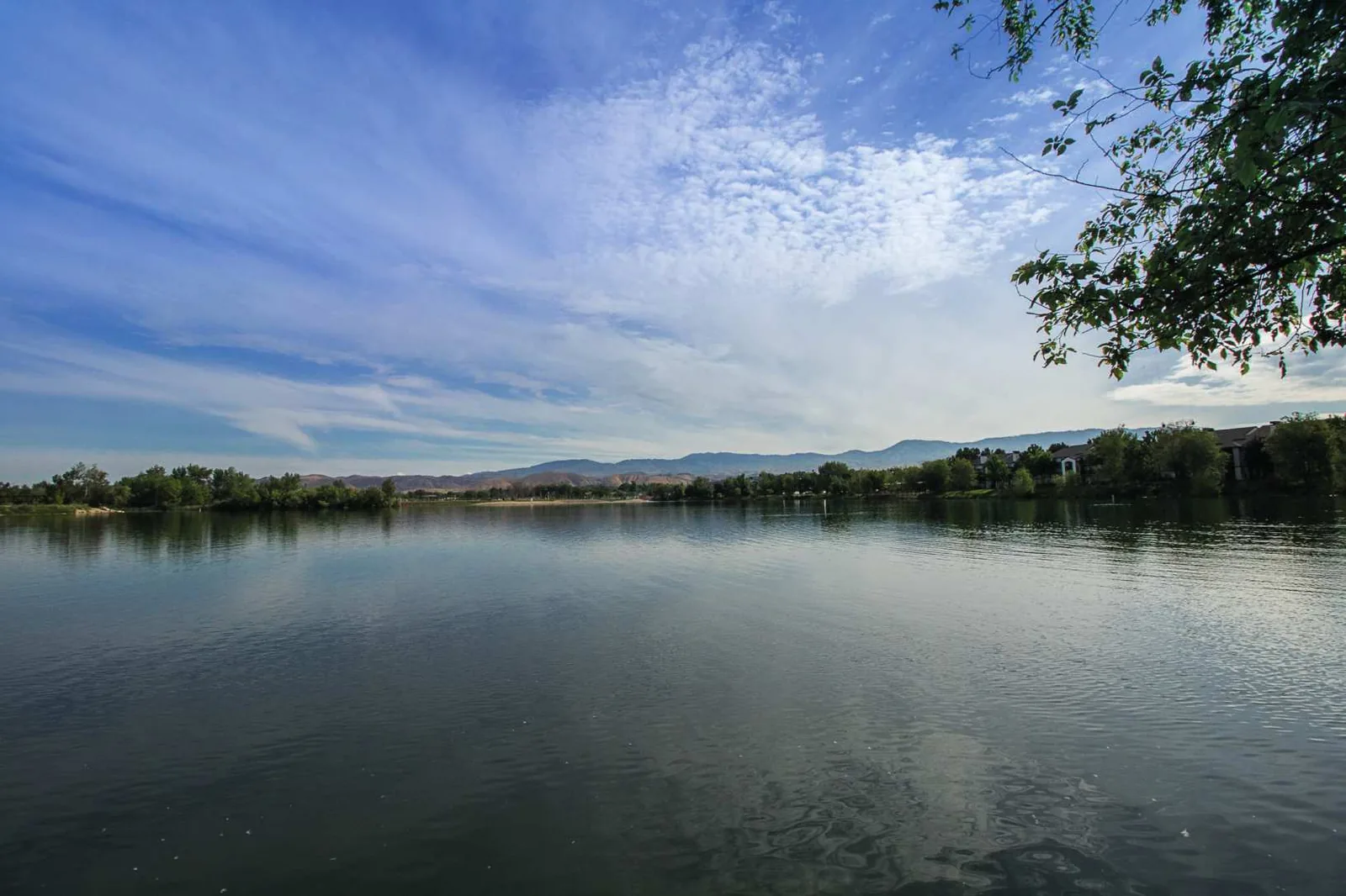 Calm Idaho lake at sunrise surrounded by mountains
